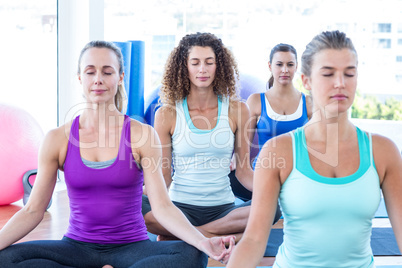 Cropped image of women doing easy pose in fitness center