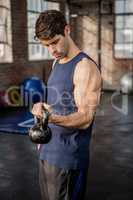 Side view of a man lifting kettlebell