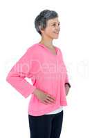 Happy mature woman with hand on hip