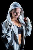 Portrait of female boxer in hood with fighting stance