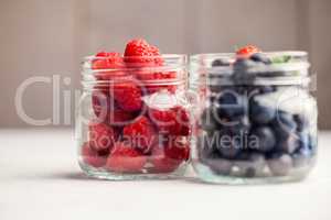 Glass jars of fresh berries