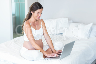 Happy woman typing on notebook