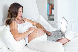 Happy woman sitting with laptop