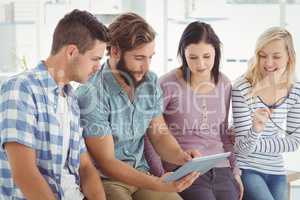 Business people using digital tablet at desk