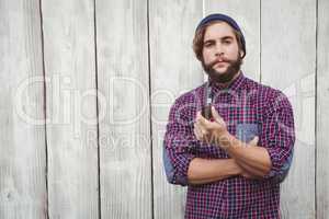 Portrait of confident hipster holding smoking pipe