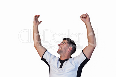 Rugby player cheering with arms raised