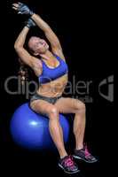Woman stretching while sitting on exercise ball