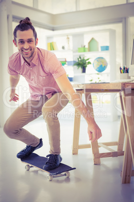 Portrait of businessman smiling while skateboarding