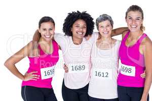 Portrait of happy female athletes with arms around