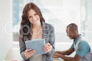 Portrait of smiling woman using digital tablet