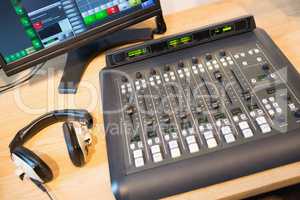 Sound mixer at desk in radio station