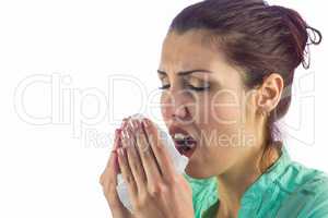 Sneezing woman holding tissue with eyes closed