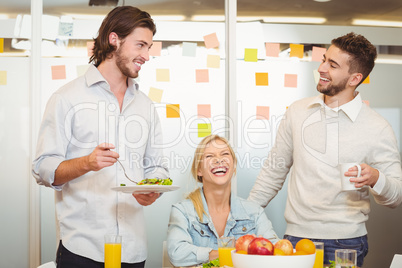 Employees having fun during breakfast