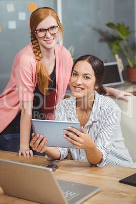 Portrait of businesswomen using digital tablet