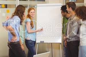 Smiling businesswoman discussing with colleagues