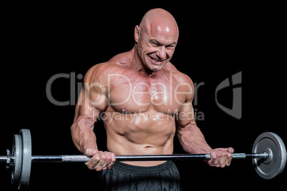 Passionate healthy man exercising while lifting crossfit