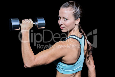 Portrait of woman lifting dumbbell