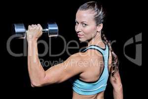 Portrait of woman lifting dumbbell