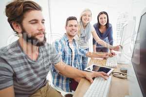Cheerful business team at computer desk