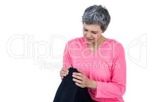 Mature woman massaging knee