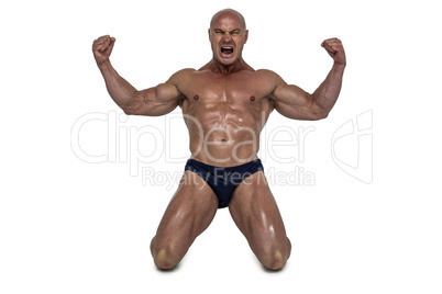 Aggressive man kneeling down with arms outstretched