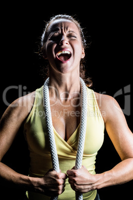 Woman shouting while holding rope