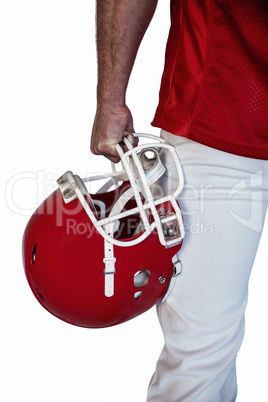 Midsection of rugby player holding helmet