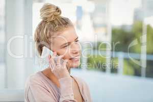 Smiling woman talking on smartphone