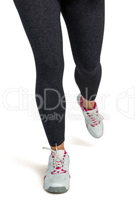 Low section of woman jogging