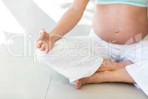 Midsection of woman practising yoga