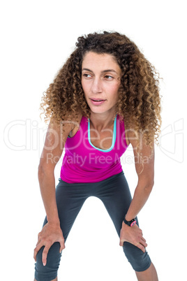 Tired young woman with hand on knees