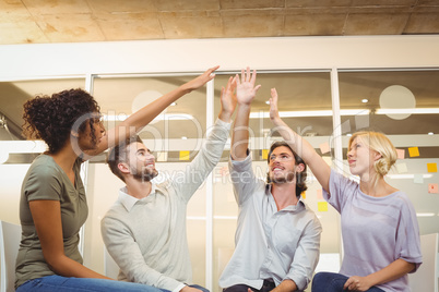 Business people with arm raised in meeting