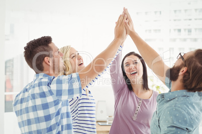 Smiling business people giving high five