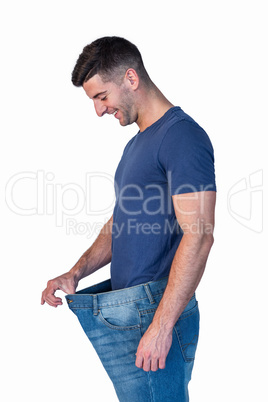 Man smiling while stretching  jeans