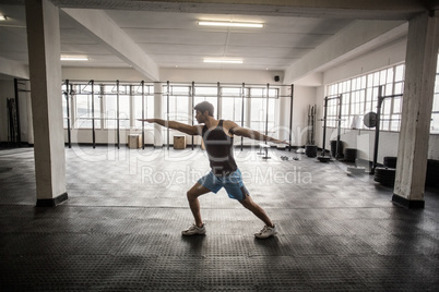 Muscular man flexing muscles in gym