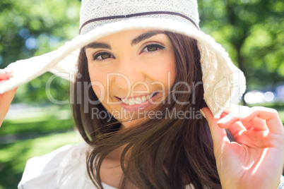 Portrait of cheerful woman in sun hat