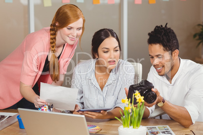 Businessman showing camera to colleagues