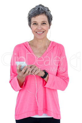 Happy woman using mobile phone while listening music