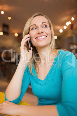 Happy young woman talking on mobile phone