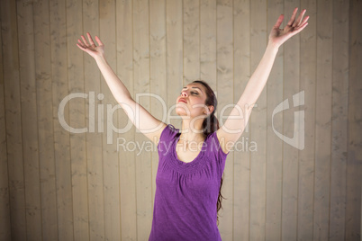 Woman with arms raised and eyes closed