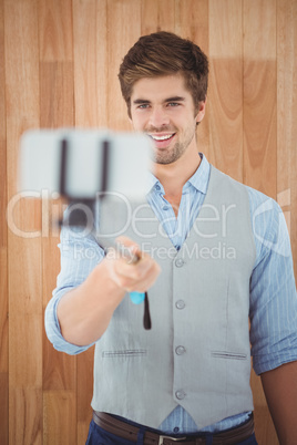 Businessman taking selfie in office