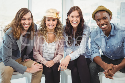 Portrait of smiling business people sitting on chair