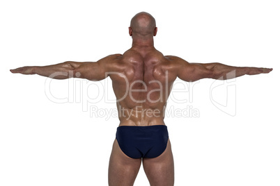 Rear view of muscular man exercising with hands