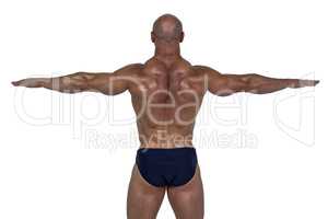 Rear view of muscular man exercising with hands