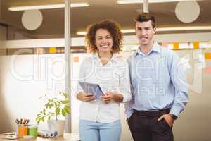 Portrait business woman using digital tablet while male colleagu