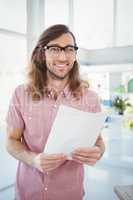 Happy hipster holding paper