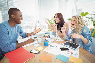 Business people laughing while working at desk