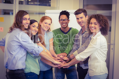 Portrait of smiling business people with hand stacked
