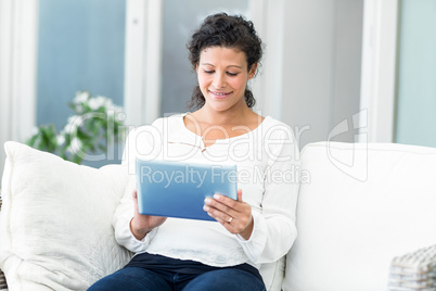 Happy woman using tablet computer