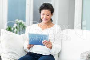 Happy woman using tablet computer